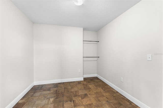 empty room featuring dark parquet flooring