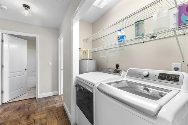 laundry area featuring gas water heater, dark parquet flooring, and separate washer and dryer