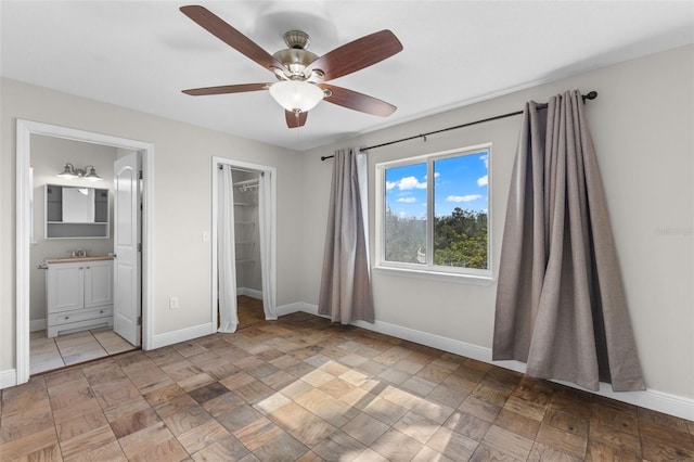 445 Horseshoe Loop Rd, Terra Ceia, FL 34250 - unfurnished bedroom featuring baseboards, a walk in closet, a sink, connected bathroom, and a closet
