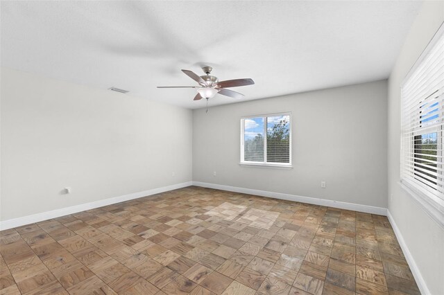 445 Horseshoe Loop Rd, Terra Ceia, FL 34250 - unfurnished room featuring healthy amount of natural light, a ceiling fan, and baseboards