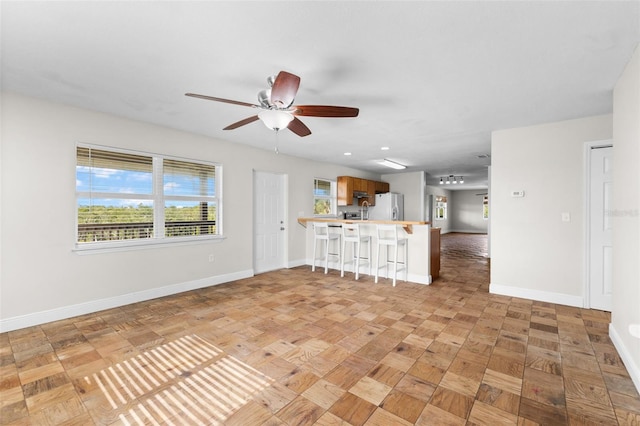 interior space with ceiling fan and light parquet flooring