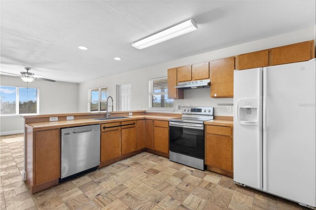 445 Horseshoe Loop Rd, Terra Ceia, FL 34250 - kitchen with appliances with stainless steel finishes, a sink, under cabinet range hood, healthy amount of natural light, and recessed lighting