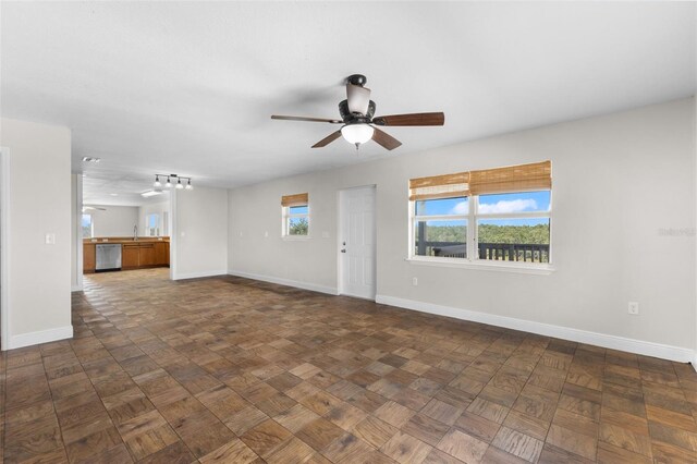 445 Horseshoe Loop Rd, Terra Ceia, FL 34250 - unfurnished living room with baseboards, a ceiling fan, and a sink
