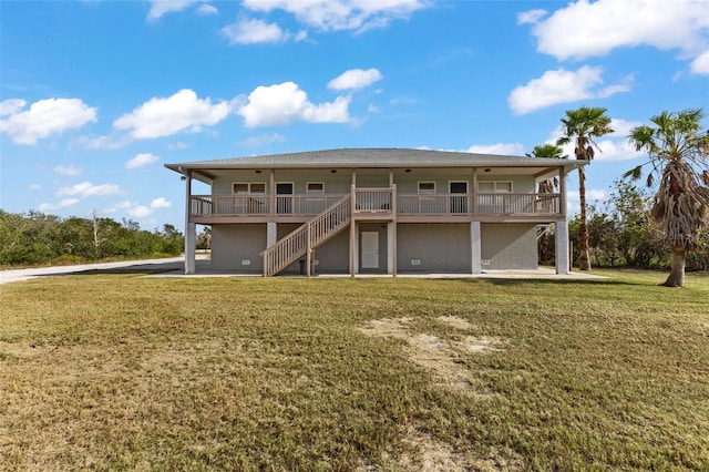 445 Horseshoe Loop Rd, Terra Ceia, FL 34250 - back of house featuring a lawn and stairway