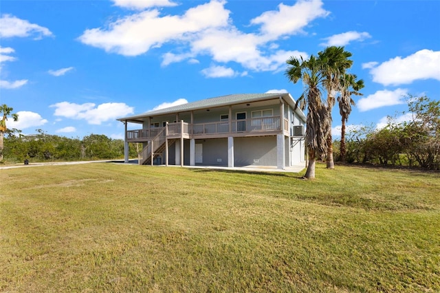 rear view of house featuring a yard, a deck, and cooling unit