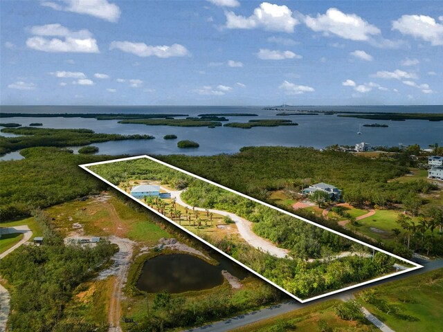 445 Horseshoe Loop Rd, Terra Ceia, FL 34250 - aerial view of property and surrounding area featuring a nearby body of water and property parcel outlined