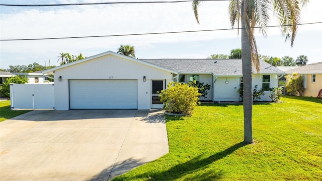 ranch-style home with a front yard and a garage