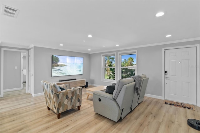 living room featuring crown molding and light wood-type flooring