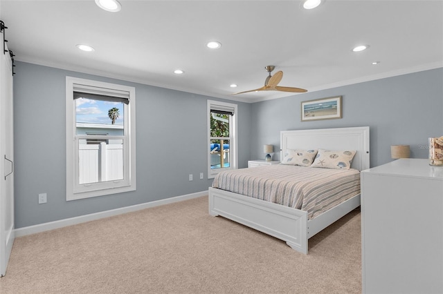 carpeted bedroom featuring multiple windows, crown molding, and ceiling fan