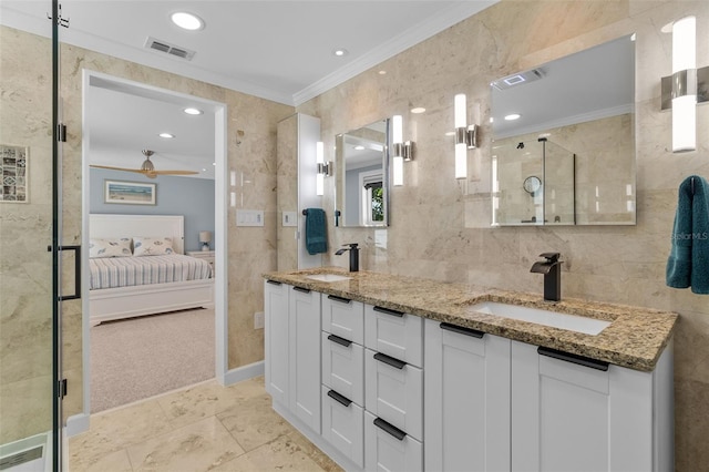 bathroom with ceiling fan, a shower with door, vanity, tile walls, and ornamental molding