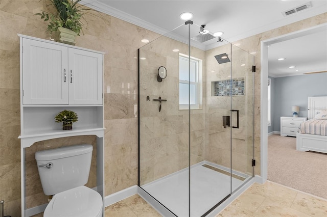 bathroom with toilet, a shower with shower door, and crown molding