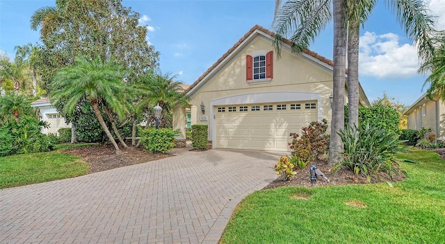 view of front of home with a garage and a front lawn