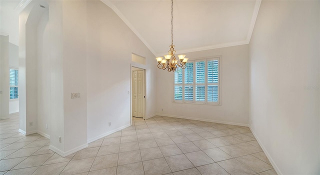 tiled spare room with a notable chandelier, crown molding, and vaulted ceiling