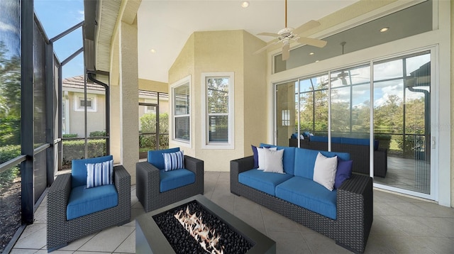 sunroom featuring lofted ceiling, ceiling fan, and a healthy amount of sunlight