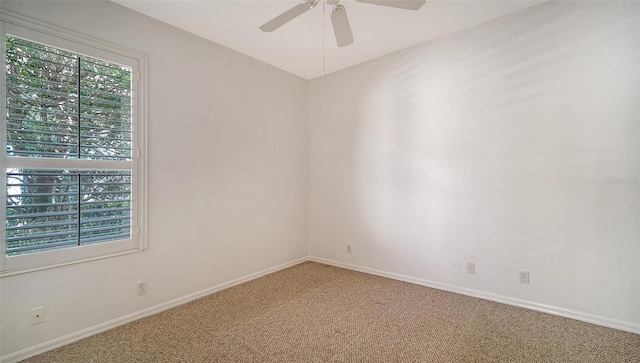 carpeted spare room with ceiling fan