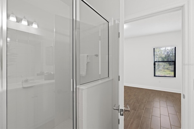 bathroom with a shower with door