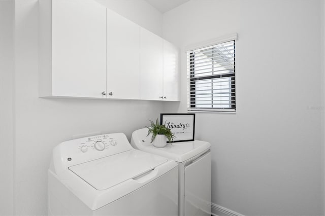 washroom featuring cabinets and independent washer and dryer