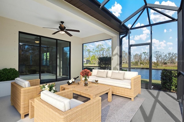 sunroom / solarium featuring ceiling fan and a water view