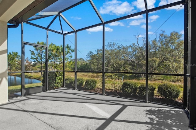 unfurnished sunroom with plenty of natural light and a water view