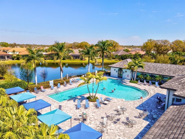 view of pool with a patio area and a water view