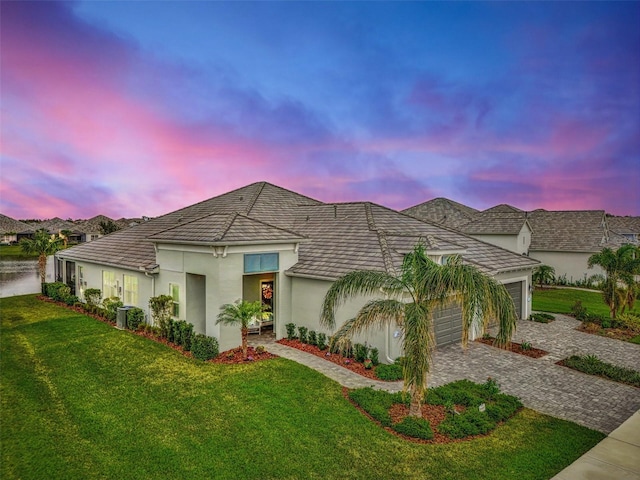 view of front of house featuring a yard and a garage