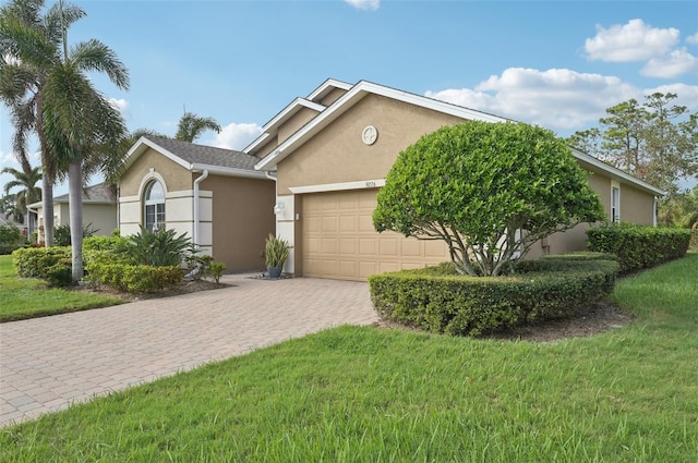 view of front of house featuring a garage and a front lawn