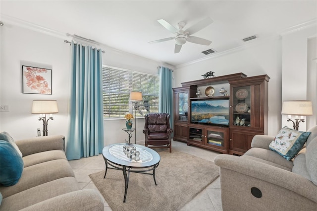 tiled living room with ceiling fan and crown molding