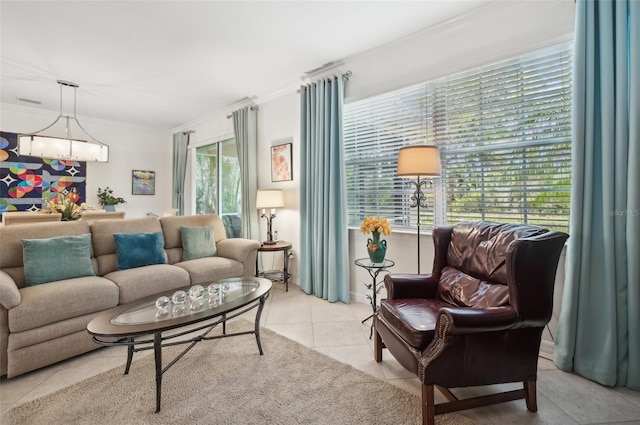 living room with a wealth of natural light, crown molding, and light tile patterned floors