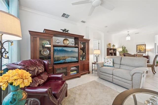 living room featuring light tile patterned floors, ceiling fan, and ornamental molding