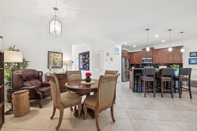 dining room with light tile patterned floors, a notable chandelier, and ornamental molding