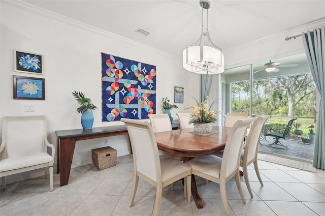 dining area with ceiling fan with notable chandelier, ornamental molding, and light tile patterned flooring