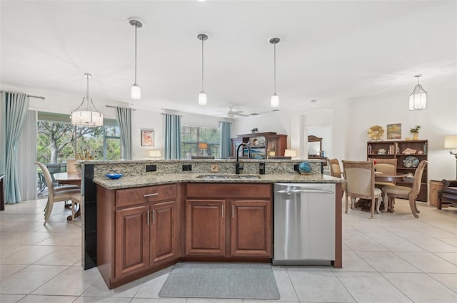 kitchen featuring decorative light fixtures, dishwasher, and sink