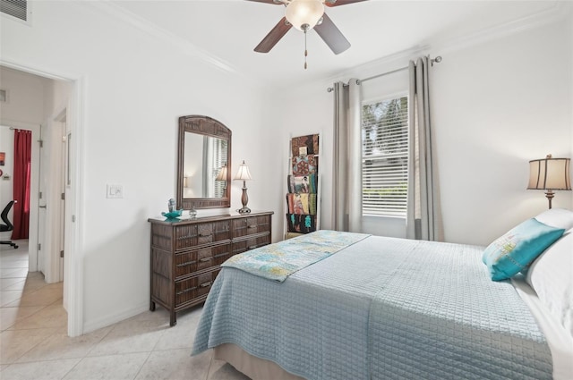 tiled bedroom with ceiling fan and crown molding