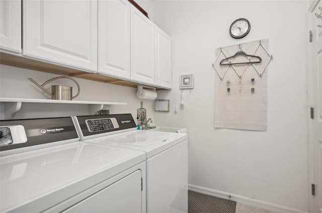 laundry area with sink, cabinets, and independent washer and dryer