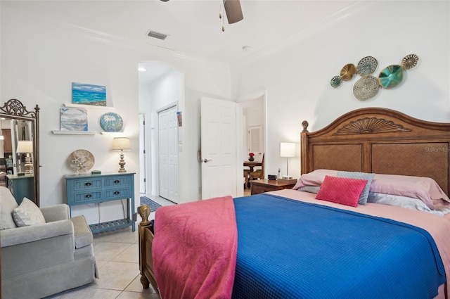 tiled bedroom featuring ceiling fan and ornamental molding