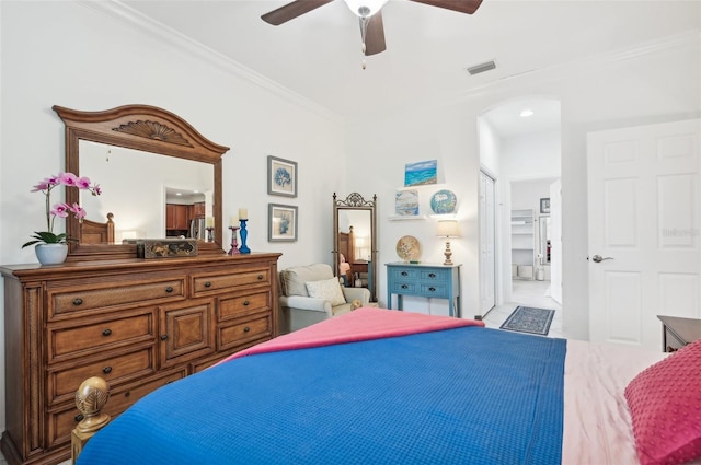 bedroom featuring ceiling fan, ornamental molding, and connected bathroom