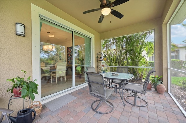 sunroom featuring ceiling fan