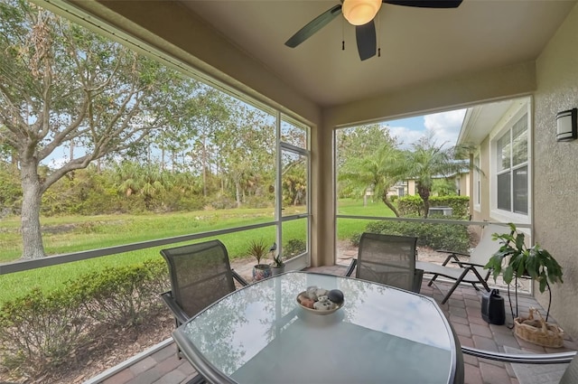 sunroom featuring ceiling fan