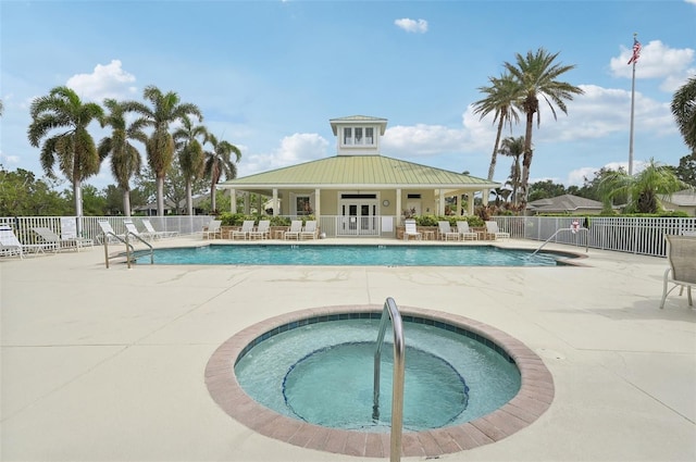 view of pool with french doors, a patio, and a community hot tub