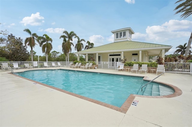 view of swimming pool with french doors and a patio