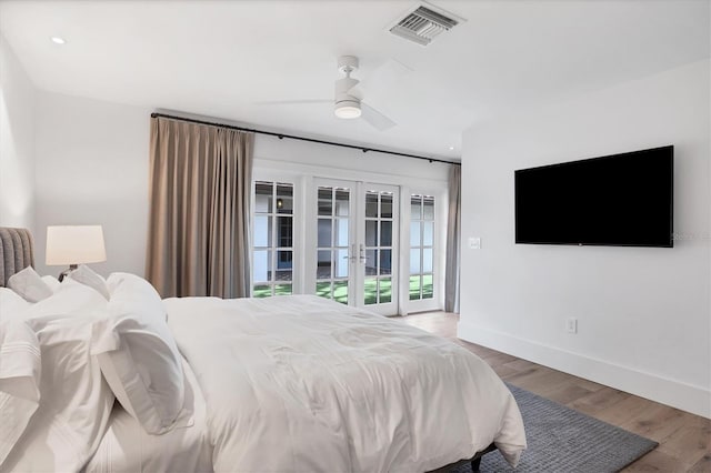 bedroom with hardwood / wood-style floors, french doors, access to outside, and ceiling fan