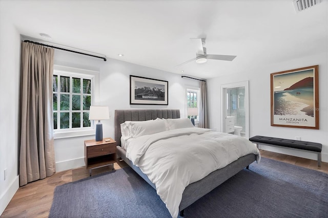 bedroom featuring ceiling fan, light wood-type flooring, and ensuite bath