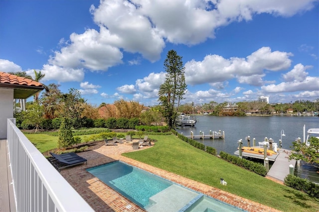 view of pool with a yard, a dock, a water view, and a patio