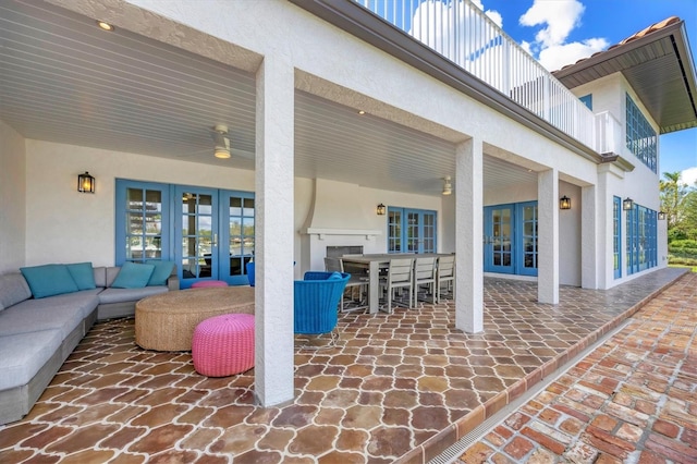 view of patio featuring outdoor lounge area, a balcony, and french doors