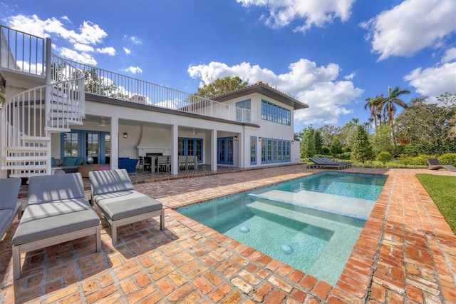 view of swimming pool with an in ground hot tub and a patio