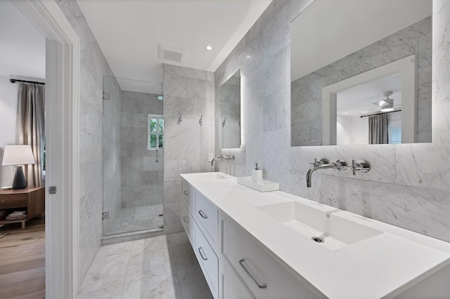 bathroom featuring tile walls, a shower with shower door, and ceiling fan