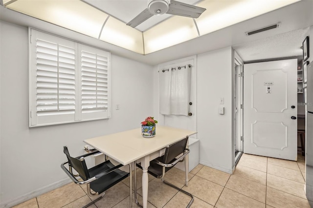 dining area featuring ceiling fan and light tile patterned floors