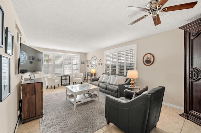 tiled living room featuring a textured ceiling and ceiling fan