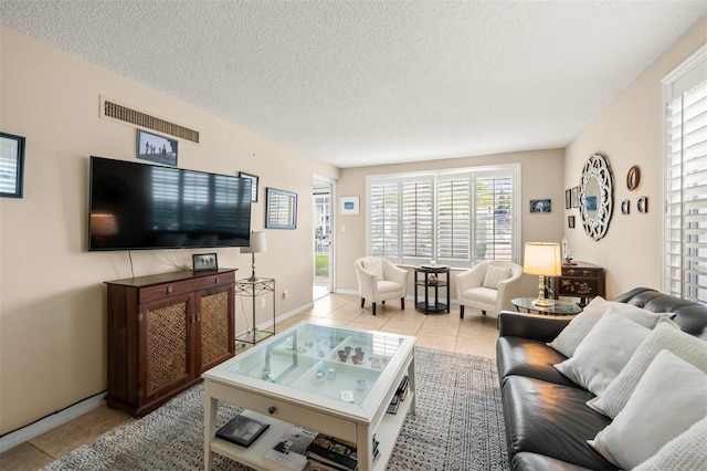 tiled living room featuring a textured ceiling