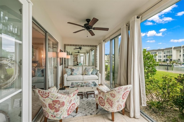 sunroom with a water view and ceiling fan